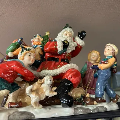 Sale Photo Thumbnail #78: Hand-painted glazed ceramic Santa Claus tabletop figurine surrounded by children and a puppy, in excellent vintage condition.