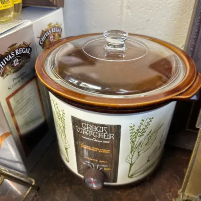Sale Photo Thumbnail #35: Vintage Hamilton Beach Scovill Crock Watcher slow cooker featuring a botanical herb design, clear glass lid, and brown stoneware crock.