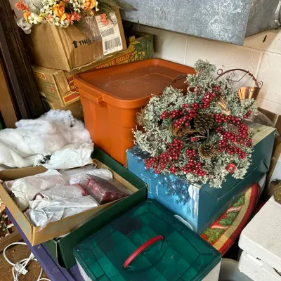 Sale Photo Thumbnail #299: Collection of seasonal holiday decor and storage containers, including faux berry wreaths, floral arrangements, wrapped ornaments, and plastic totes.