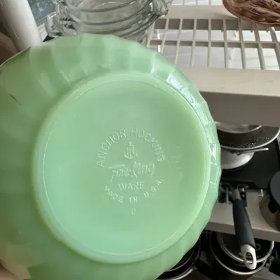 Sale Photo Thumbnail #688: Vintage Anchor Hocking Fire-King Jadeite swirl bowl showing the embossed maker's mark on the base.