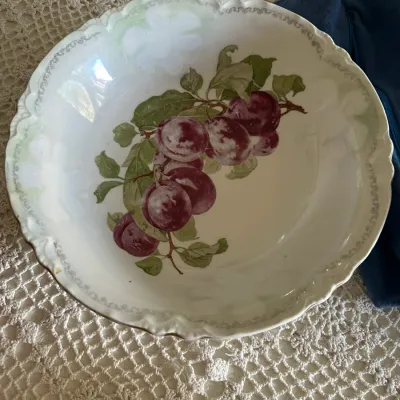 Sale Photo Thumbnail #588: Vintage porcelain serving bowl featuring a central plum branch motif, scalloped lusterware rim, and subtle filigree detailing.