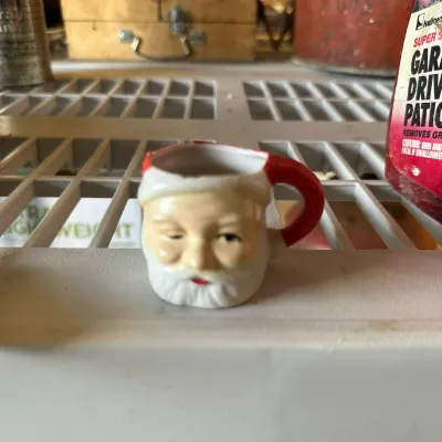 Sale Photo Thumbnail #571: Vintage miniature ceramic Santa Claus mug featuring hand-painted details and a red handle.