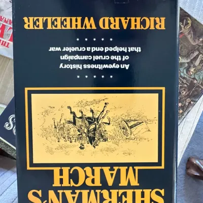 Sale Photo Thumbnail #430: Hardcover book titled 'Sherman's March' by Richard Wheeler, featuring a dark blue dust jacket with gold lettering and an illustrated front panel.