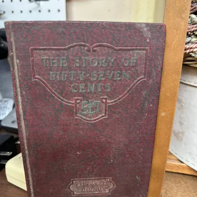 Sale Photo Thumbnail #308: Vintage hardcover book titled 'The Story of Fifty-Seven Cents' from the Conwell Library series, featuring a embossed red cloth cover.