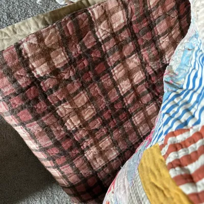 Sale Photo Thumbnail #357: Vintage handmade quilt featuring a brown and pink plaid pattern alongside another colorful patchwork quilt.