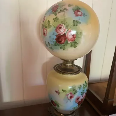 Sale Photo Thumbnail #375: Vintage Gone with the Wind-style table lamp featuring hand-painted floral rose motifs on a cream glass body and matching globe shade.