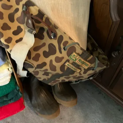 Sale Photo Thumbnail #614: Vintage Hodgman Wadewell camouflage hunting waders with attached boots, showing original brand patches and suspenders.