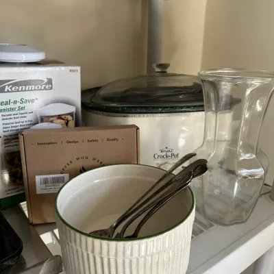 Sale Photo Thumbnail #665: Assorted kitchenware including a Rival Crock-Pot, Kenmore Seal-n-Save canister set in box, coffee mug warmer, ceramic bowl with spoons, and a clear glass vase.
