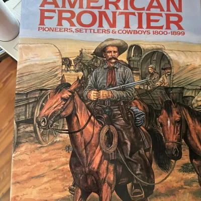 Sale Photo Thumbnail #422: Hardcover book titled "The American Frontier: Pioneers, Settlers & Cowboys 1800-1899" by William C. Davis, featuring an illustrated dust jacket.