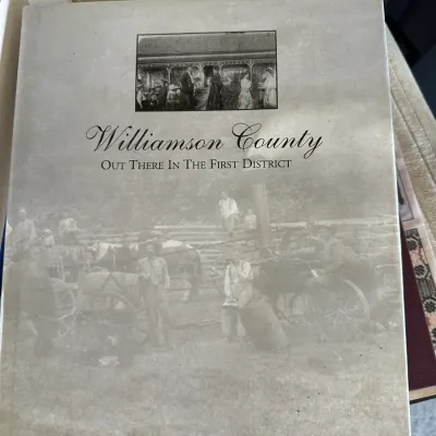 Sale Photo Thumbnail #423: Hardcover history book titled "Williamson County: Out There in the First District," featuring a printed dust jacket with historical photographs.