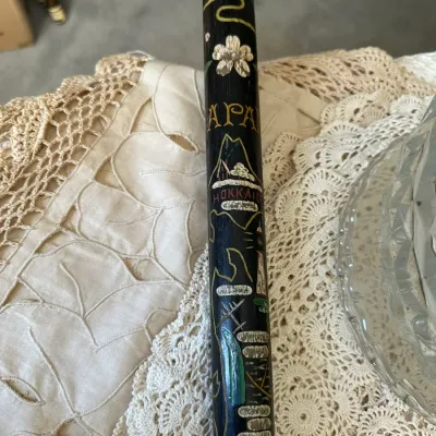 Sale Photo Thumbnail #377: Vintage hand-painted Japanese souvenir wooden walking stick featuring artwork of Mount Fuji, cherry blossoms, and Hokkaido.