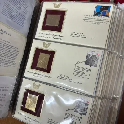 Sale Photo Thumbnail #115: Collector album featuring Postal Commemorative Society First Day Covers with 22kt gold replica stamps, housed in clear protective sleeves.
