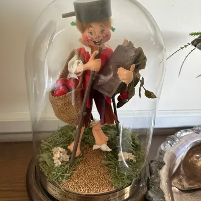 Sale Photo Thumbnail #591: Analee Doll Society Folk Hero Series Johnny Appleseed figure from 1984, displayed inside a glass cloche on a wooden base.