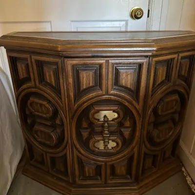 Sale Photo Thumbnail #579: Vintage 1970s brutalist-style wood dry bar cabinet featuring intricate carved geometric patterns and brass hardware.