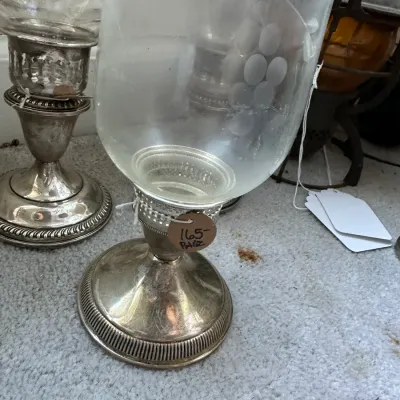 Sale Photo Thumbnail #404: Pair of silver-plated hurricane candle lamps with etched glass shades featuring a grape motif.