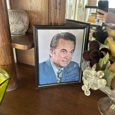 Sale Photo Thumbnail #255: Framed autographed portrait of former Alabama Governor George Wallace and Lurleen Wallace, displayed in a black frame.