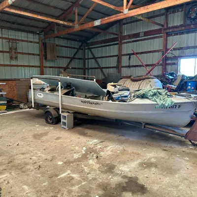 Sale Photo Thumbnail #751: Vintage Aluma Craft aluminum motorboat named 'Hootenanny' on a single-axle trailer, fitted with a Johnson outboard motor.