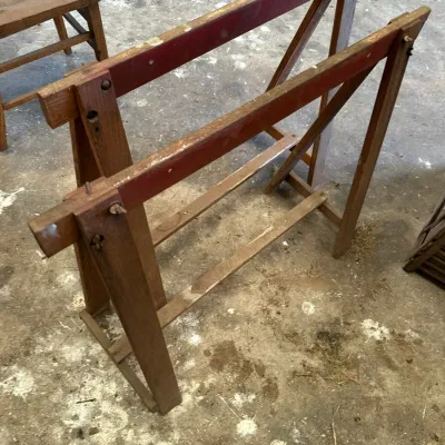 Sale Photo Thumbnail #528: Vintage wooden quilting frame with red-painted top crossbars and wing nut fasteners, showing light wear.