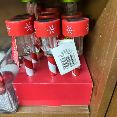 Sale Photo Thumbnail #304: Set of holiday solar pathway lights featuring red tops with snowflake details and candy cane stripe stakes.