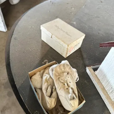 Sale Photo Thumbnail #738: Vintage white leather Baby Deer Shoes in original box, showing heavy age-related wear and discoloration.