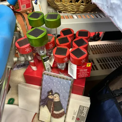 Sale Photo Thumbnail #29: Collection of holiday solar garden stakes with red candy cane patterns and green caps, paired with a pack of snowman stationery.