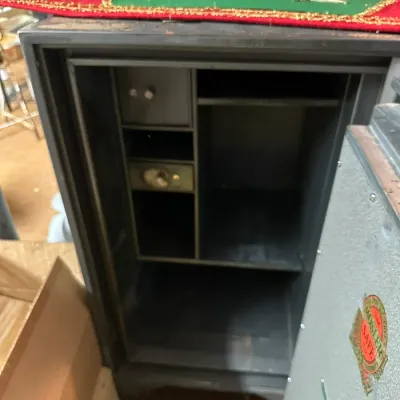 Sale Photo Thumbnail #287: Open Mosler brand floor safe featuring internal compartments, shelves, and a small locking drawer.