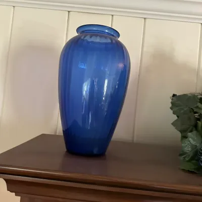 Sale Photo Thumbnail #644: Cobalt blue glass urn-shaped vase featuring subtle vertical optic ribbed detailing and a flared rim.