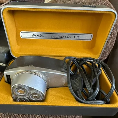 Sale Photo Thumbnail #616: Vintage Norelco Tripleheader VIP electric shaver housed in its original yellow velvet-lined hard shell case.