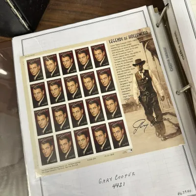 Sale Photo Thumbnail #108: Unused 2009 USPS Legends of Hollywood Gary Cooper 44-cent commemorative stamp sheet in a collector's binder page.