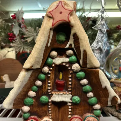 Sale Photo Thumbnail #71: Vintage ceramic gingerbread house covered jar featuring a star topped snowy roof and painted candy details.