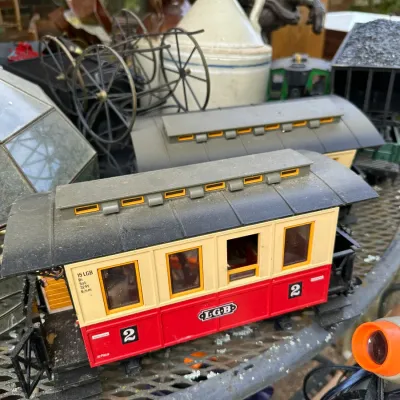 Sale Photo Thumbnail #168: Vintage LGB G-scale passenger train car displayed alongside vintage stoneware crocks and metal wagon decor.