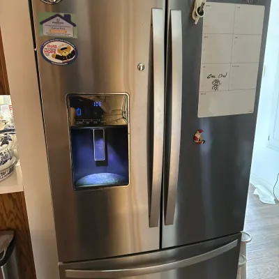 Sale Photo Thumbnail #153: Whirlpool stainless steel french door refrigerator featuring an exterior ice and water dispenser.