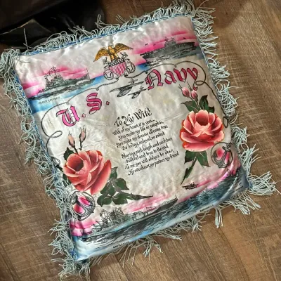 Sale Photo Thumbnail #358: Vintage World War II-era U.S. Navy pillow cover, featuring printed graphics of military ships, a poem dedicated "To My Wife," painted roses, and light blue fringe trim.