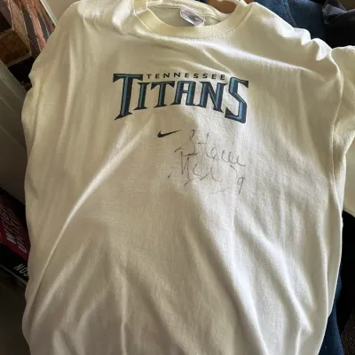 Sale Photo Thumbnail #608: Vintage white Nike Tennessee Titans t-shirt, featuring a faded autograph under the team logo.