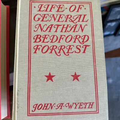 Sale Photo Thumbnail #417: Hardcover copy of "Life of General Nathan Bedford Forrest" by John A. Wyeth, featuring a grey cloth cover with red lettering and star accents.