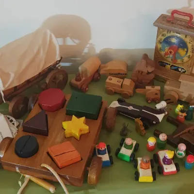 Sale Photo Thumbnail #21: Collection of vintage wooden toys, including a covered wagon, shape-sorting pull toy, cars, and a Fisher-Price Hickory Dickory Dock clock toy.