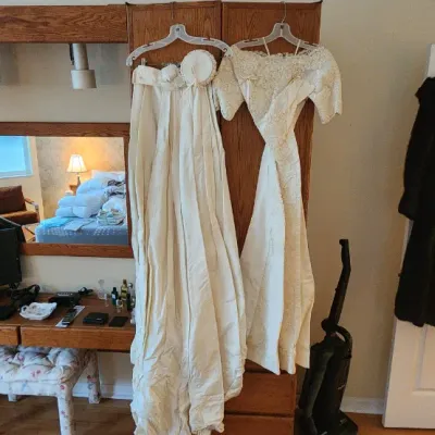 Sale Photo Thumbnail #95: Vintage off-white wedding gowns and dark fur coats hanging near a large oak bedroom wall unit vanity system.