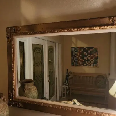 Sale Photo Thumbnail #43: Large rectangular wall mirror featuring an ornate gilded frame with carved corner accents and a white inner lip.