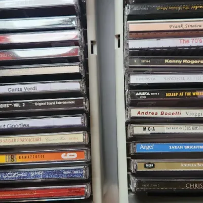 Sale Photo Thumbnail #85: Collection of compact discs in jewel cases, featuring classical crossover, pop, and holiday albums by artists including Andrea Bocelli, Frank Sinatra, and Kenny Rogers.