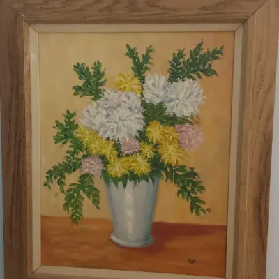 Sale Photo Thumbnail #189: Framed floral still life oil painting depicting chrysanthemums in a vase, signed lower right, set in a rustic oak wooden frame.