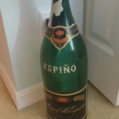Sale Photo Thumbnail #200: Large vintage green glass Espino Champagne Argentino display bottle featuring original paper labels with visible wear.