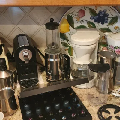 Sale Photo Thumbnail #219: Collection of kitchen small appliances and coffee gear, including Nespresso machines, milk frothers, teapots, and a mini coffee maker.