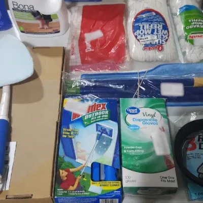 Sale Photo Thumbnail #372: Assortment of household cleaning supplies, including a Glass Wizard cleaning tool, Windex Outdoor tool, floor cleaners, mop refills, disposable gloves, and Shop-Vac dry filters.