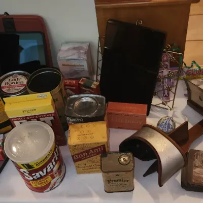 Sale Photo Thumbnail #142: Collection of vintage items including a stereoscope with stereo cards, vintage product tins and boxes like Savarin coffee and Bon Ami, alongside modern electronics.