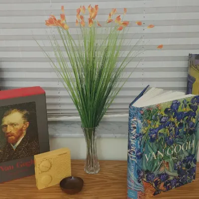 Sale Photo Thumbnail #310: Collection of art history coffee table books featuring Vincent van Gogh and Pablo Picasso, displayed alongside a small vintage radio, a small dish, and artificial flowers in a glass vase.