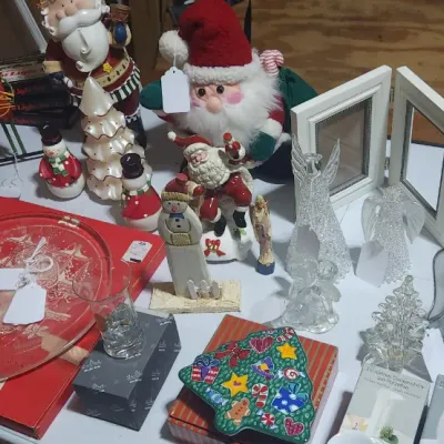 Sale Photo Thumbnail #328: Collection of Christmas decorations including nutcrackers, plush and ceramic Santas, glass angel figurines, picture frames, and holiday serving pieces.
