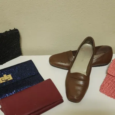 Sale Photo Thumbnail #69: Collection of women's accessories including a pair of brown leather loafers and various evening clutches in beaded, glitter, and woven styles.