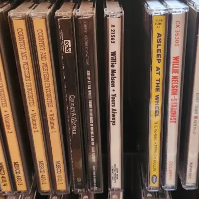 Sale Photo Thumbnail #83: Collection of country music CDs in jewel cases, featuring artists such as Willie Nelson, Randy Travis, and Asleep at the Wheel.