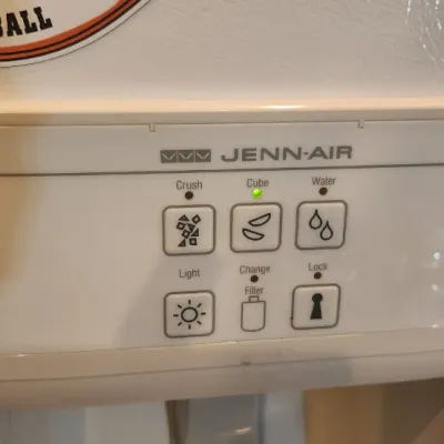 Sale Photo Thumbnail #228: Jenn-Air refrigerator door ice and water dispenser panel in working condition with illuminated indicators.
