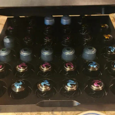 Sale Photo Thumbnail #218: Black wooden espresso pod storage drawer filled with an assortment of coffee capsules.